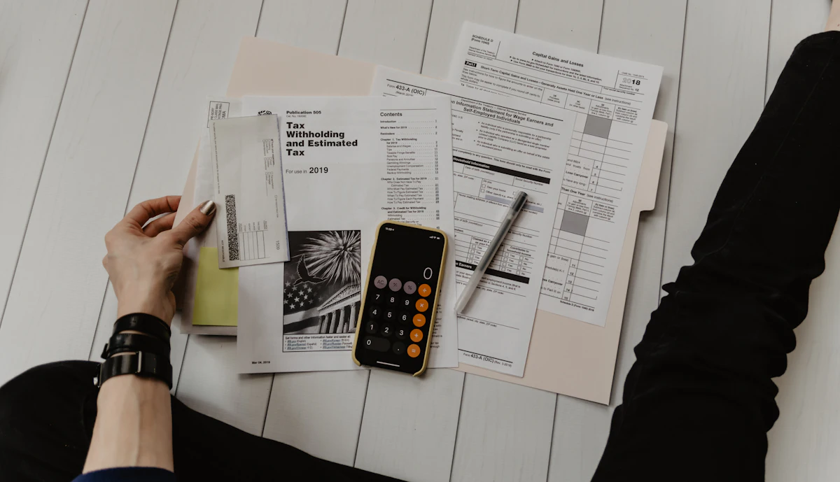 Receipts, a calculator, and a pen on a desk